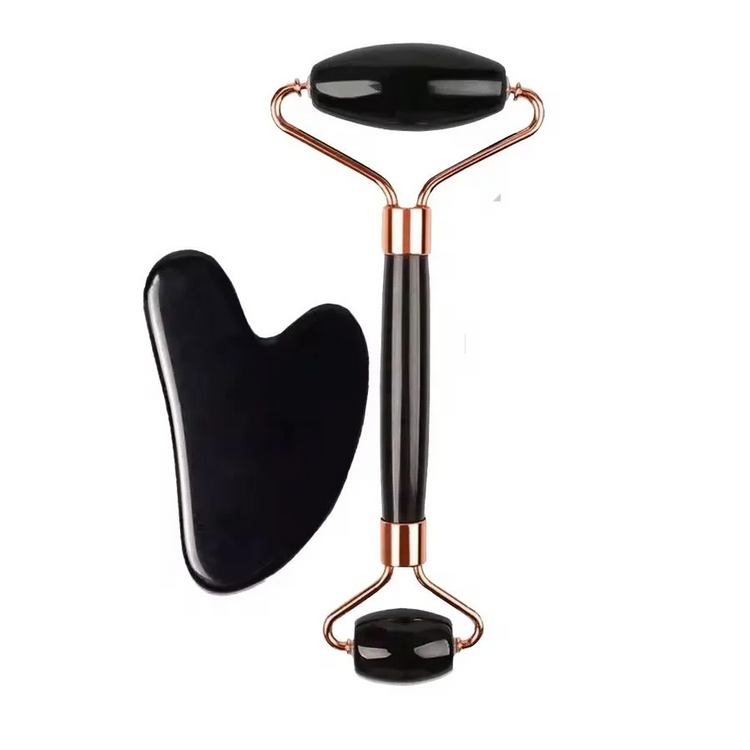 Black dual-ended face roller with gold-tone frame and black heart-shaped gua sha
