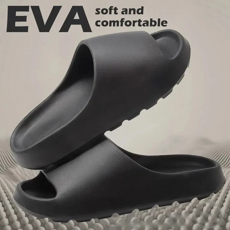 Pair of black EVA cloud slides showing the thick textured sole