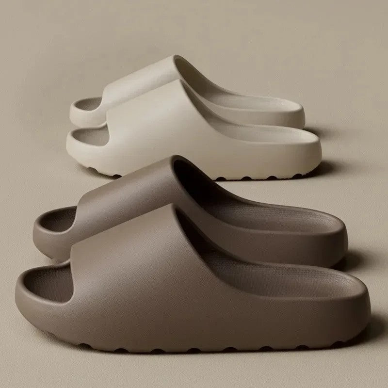Two cloud slides side by side in light beige and brown, showing the thick cushioned soles